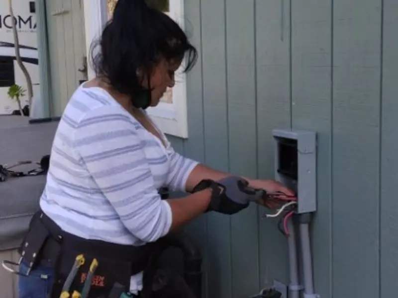 Licensed electrician wiring an exterior subpanel in Cortez