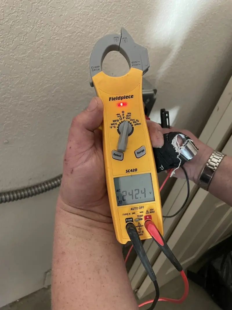 Voltage testing with clamp meter during Outlet Installation in Cortez